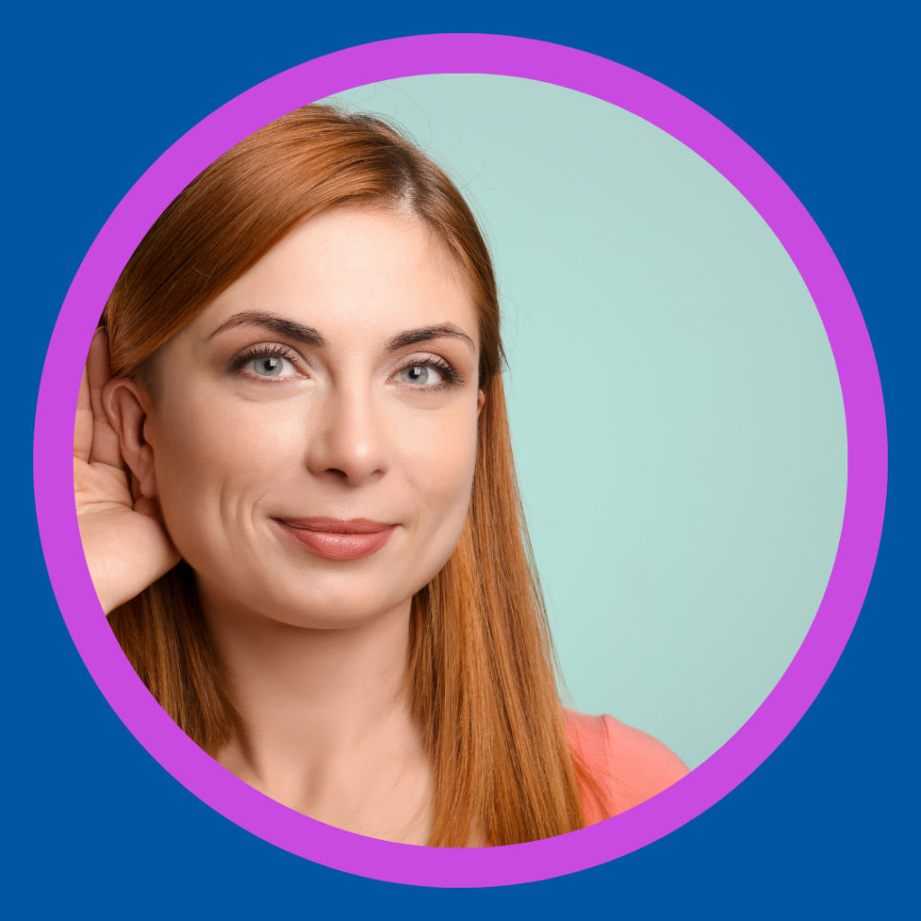 A woman cups her ear to hear better.