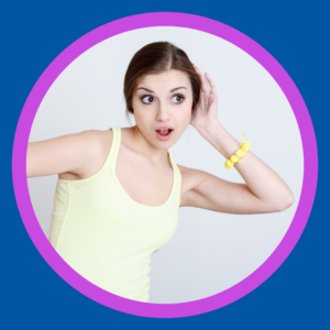 A woman cups her ear and leans to hear better. 
