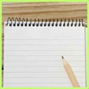 A pencil sits on top of a notebook. 