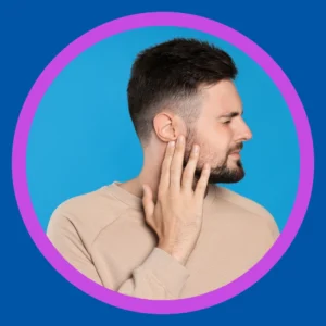 A man touches his ear. 