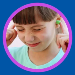A little girl holds ear plugs in her ears.