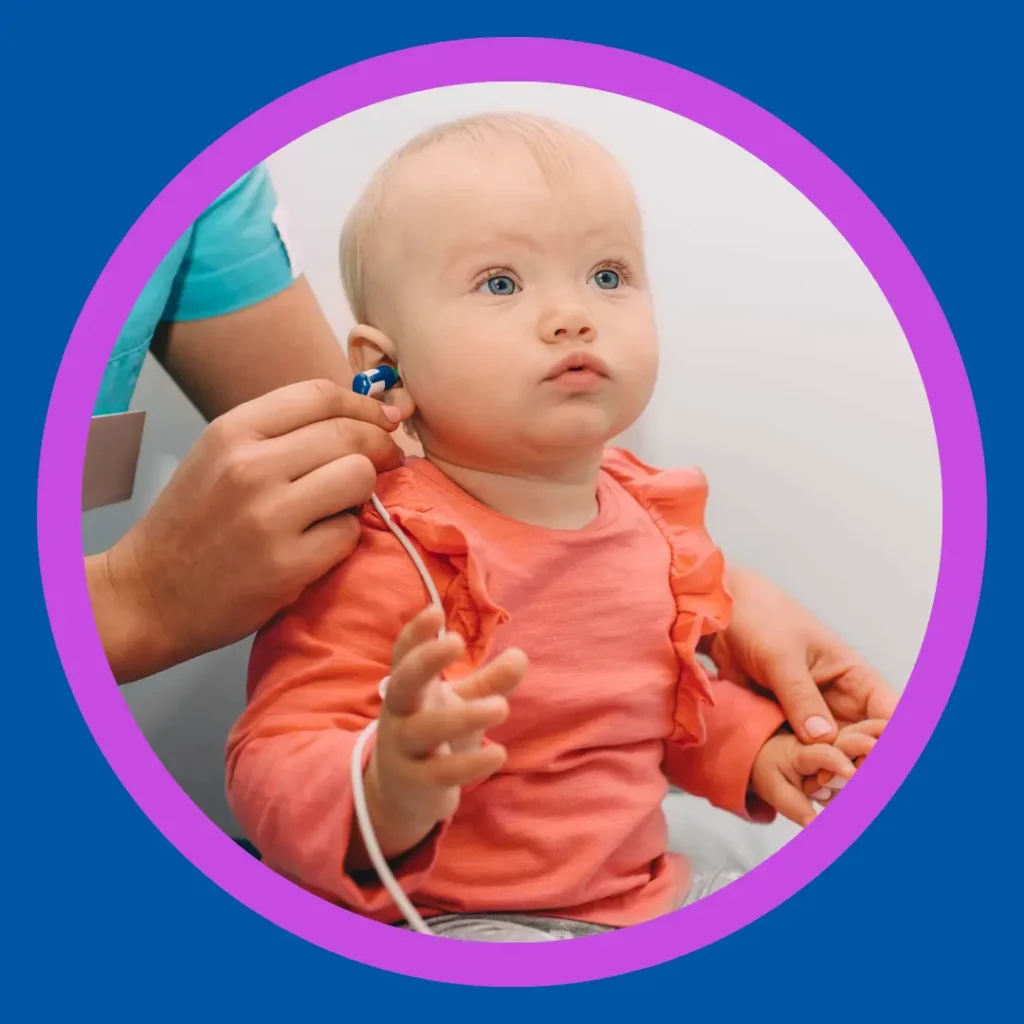 An audiologist checks a baby's hearing.