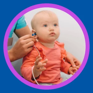 An audiologist checks a baby's hearing.