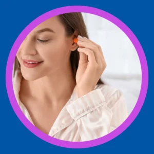 A woman puts an ear plug into her ear. 