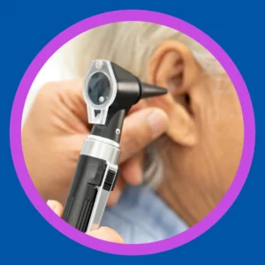 An audiologist looks into a patient's ear. 