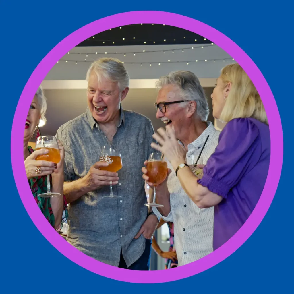 Older friends laugh together.