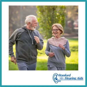 A couple jogs together outside. 