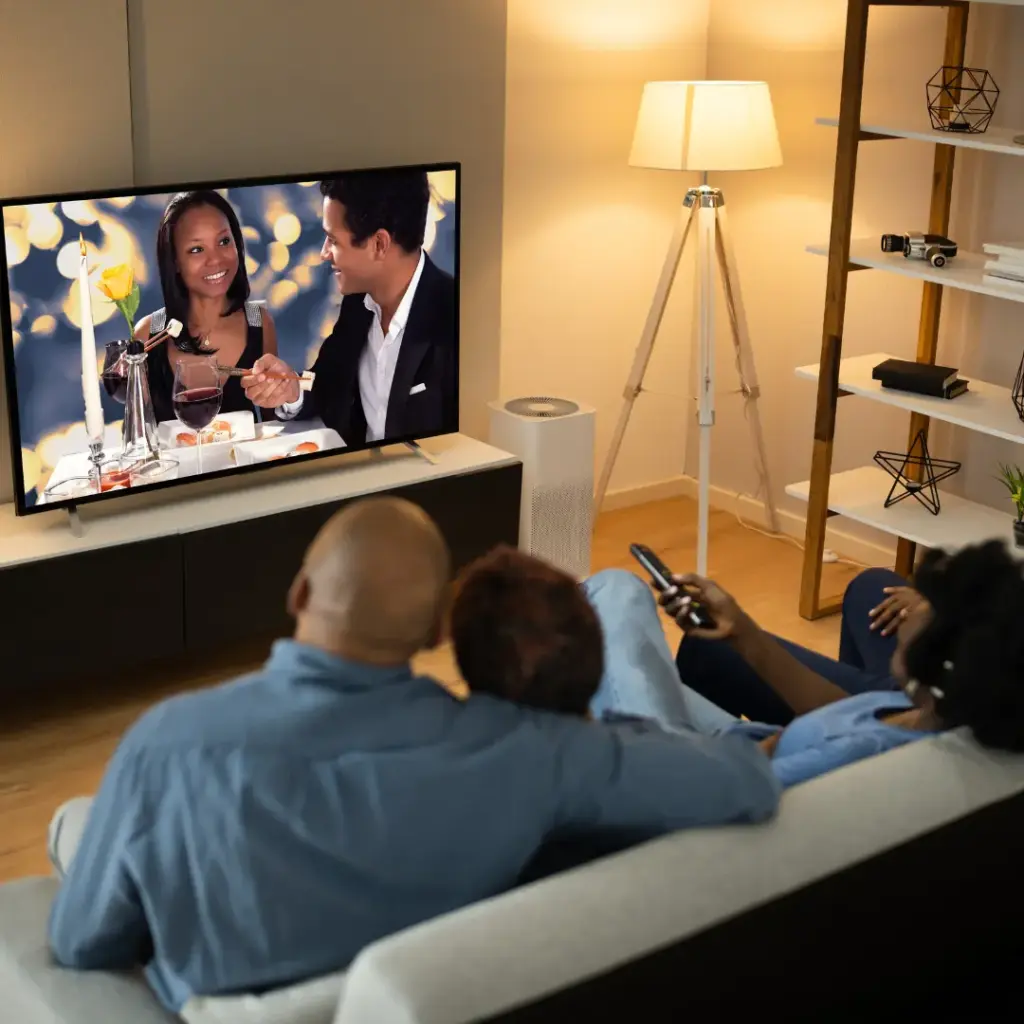 A family watches a movie at home.