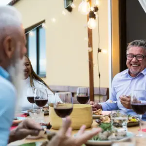 Older friends enjoy a dinner out. 