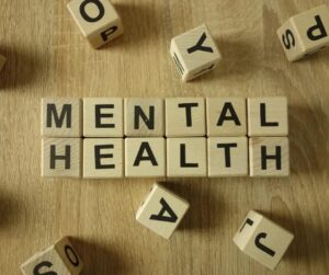 Scrabble letters spell out the words “Mental Health.”