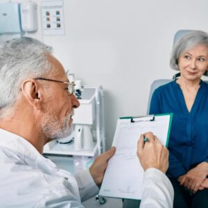 An audiologist consults with a patient.