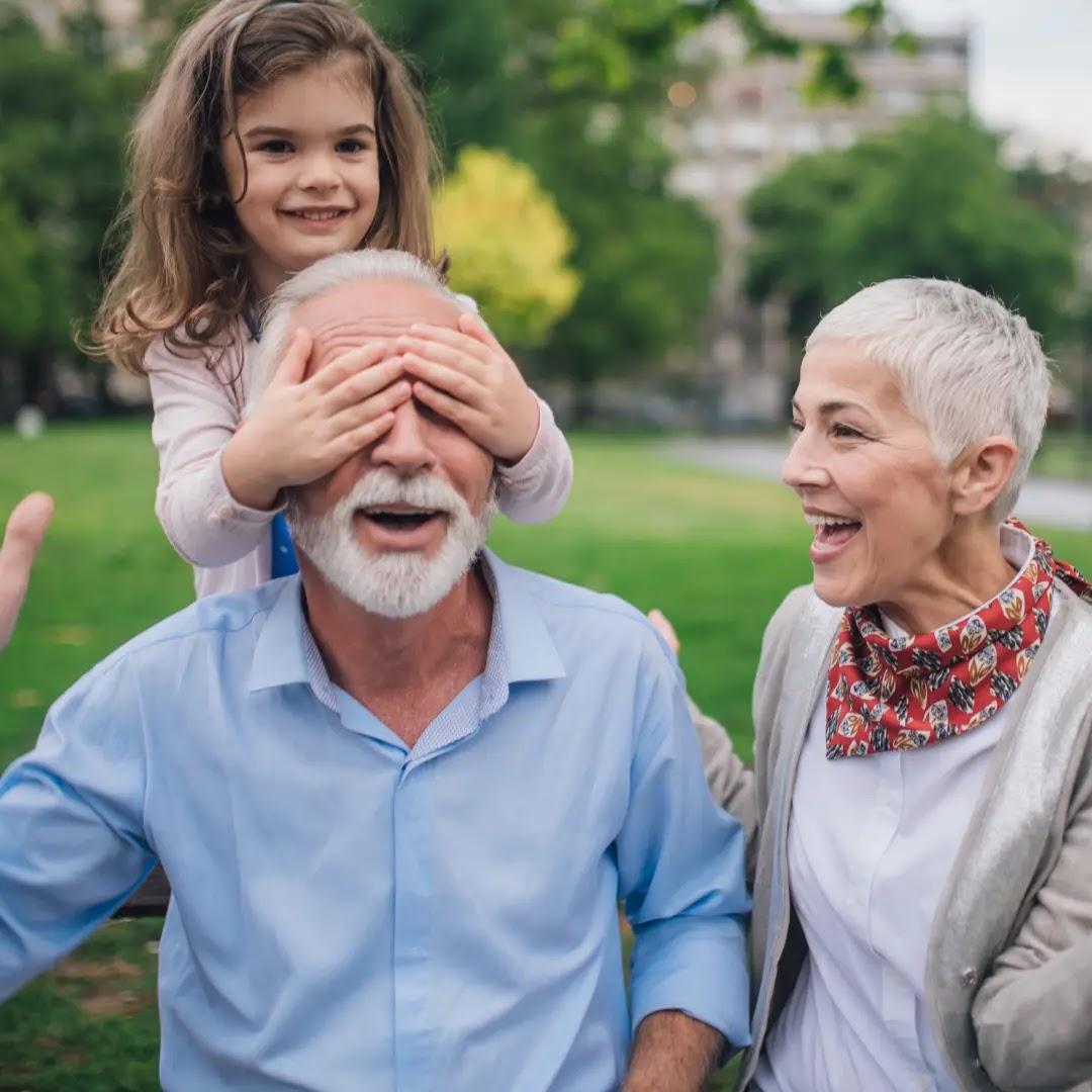 A young girl plays with her grandparents.