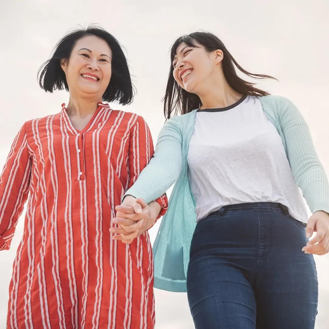 An adult daughter goes on a walk with her mom.