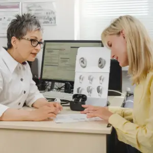 A woman and her hearing care specialist discuss test results.