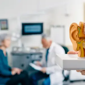 A woman meets with her audiologist. 