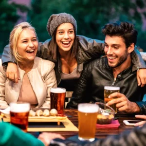 Friends enjoy a night out with beer and snacks. 