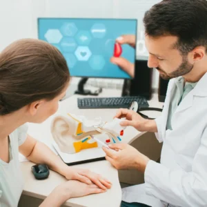 An audiologist explains hearing issues to a patient.