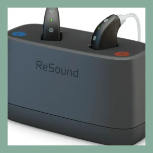 Black ReSound behind-the-ear hearing aids sit in their charging case.