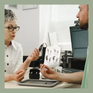 An audiologist discusses hearing aids with her patient.