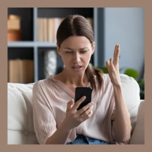 A woman throws her hand up in exasperation during a video call.