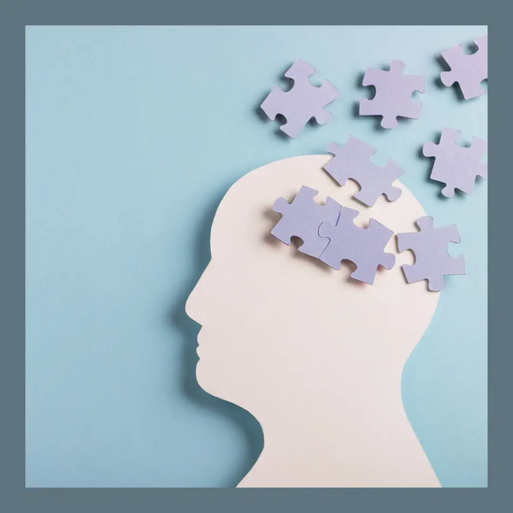 A silhouette of a head shows puzzle pieces flying out of it.