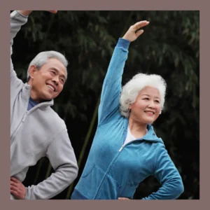 An older couple stretches together. 
