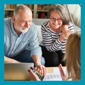 A couple consults with an audiologist in her office. 