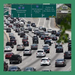 A highway is crowded with cars and signs. 