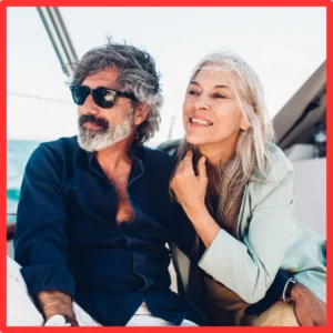 An older couple rides on a yacht. 