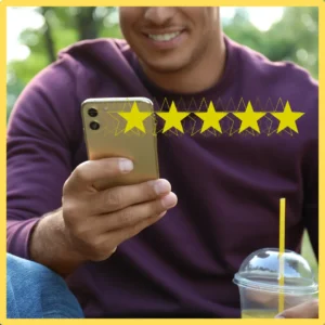 A man looks at his phone, there are 5 stars superimposed over it. 