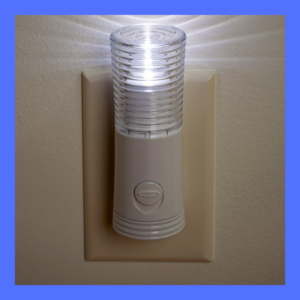 A safety light is plugged into a wall socket. 