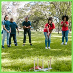 A family plays a game together outside. 