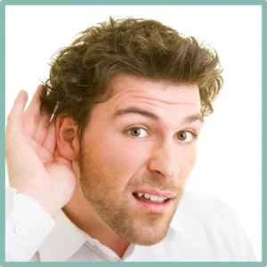 A man cups his hand around his ear to hear better.