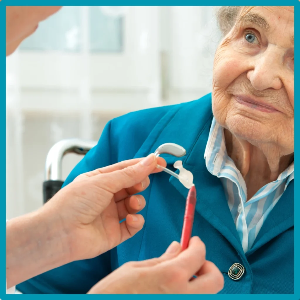 An older woman smiles during a hearing appointment.