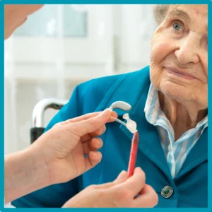 An older woman smiles during a hearing appointment.