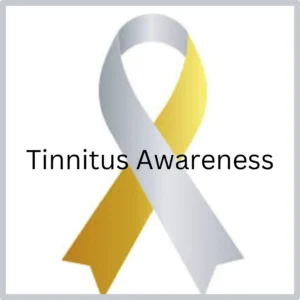 A silver and gold tinnitus awareness ribbon sits on a white background. 
