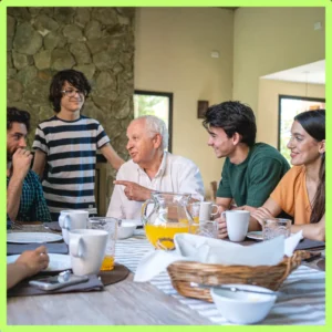 An extended family gathers at a dining table.