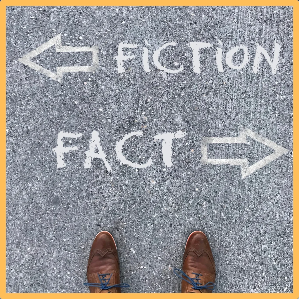 The words "fiction" and "fact" are written on chalk on blacktop.