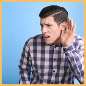 A younger man cups his ear to hear better. 