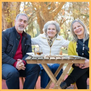 Older friends enjoy drinks outside. 