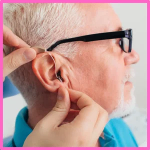A man smiles during his hearing aid fitting.