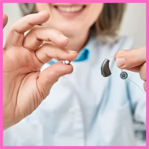 An audiologist shows a hearing aid. 