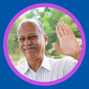A man smiles and waves. 