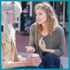 A woman speaks earnestly to her mother. 
