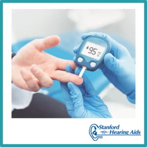 A person gets their finger pricked with a glucose monitor.