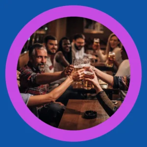 Friends toast together at a bar.