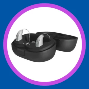 Rechargeable hearing aids sit in their charging case. 