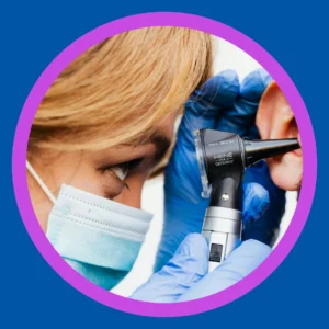 An audiologist looks in a patient's ear. 