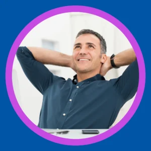 A man leans back and relaxes with his hands behind his head. 
