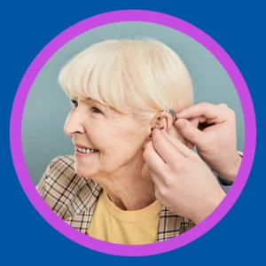 An older woman smiles at her hearing aid fitting. 